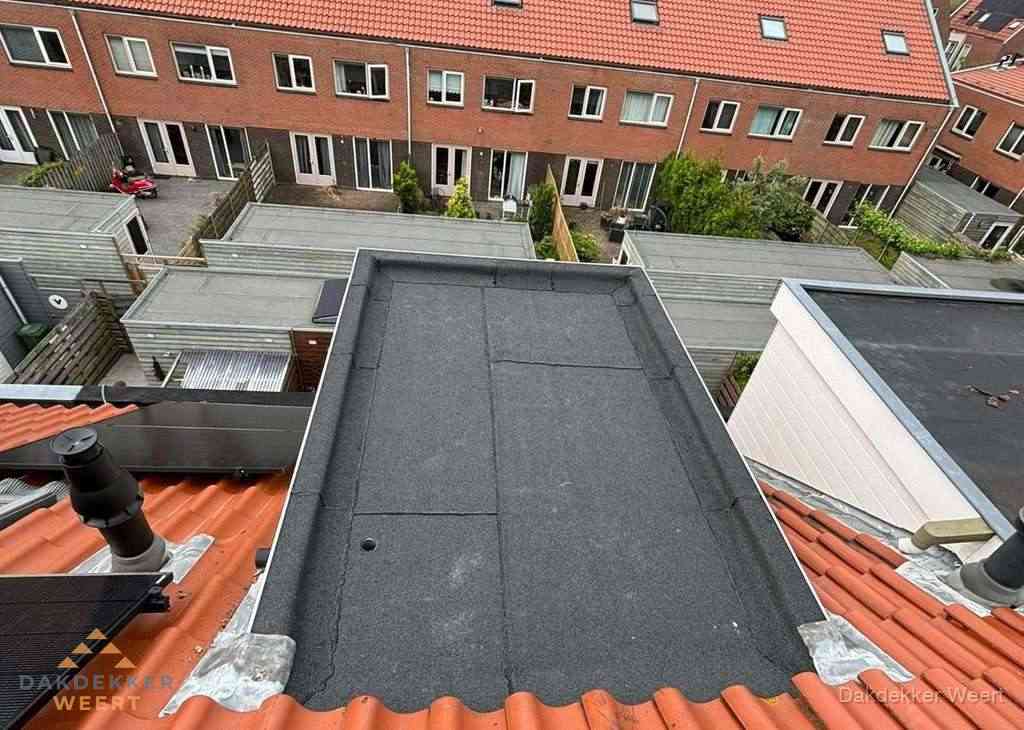 Plat dak met bitumen bedekking naast dakkapel in Weert
